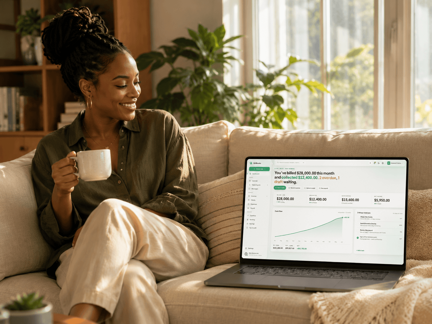 The GíríBooks dashboard open on a laptop at home, coffee in hand